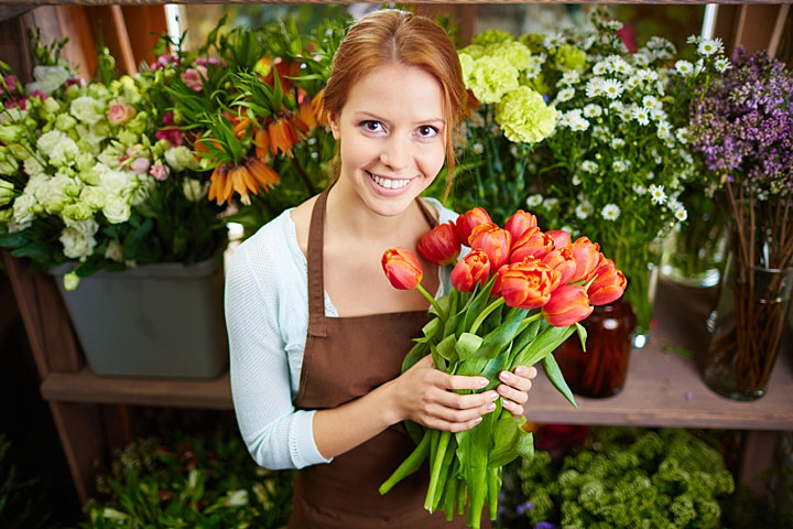 pretty florist holding a bunch of tulips